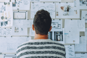 Man at a desk looking at the wall